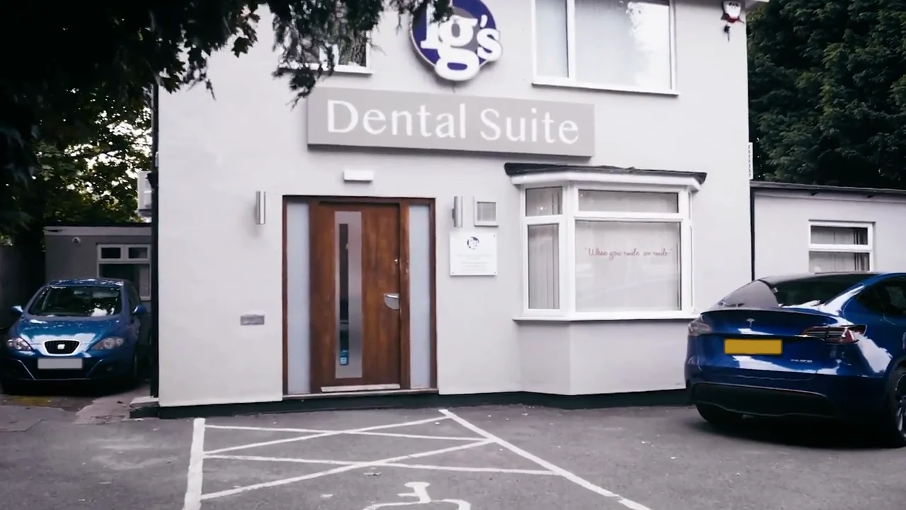 The front of TG's Dental Suite Ashby: the white building with the Tg's Dental Suite sign, wooden front door and bay window