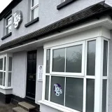 The TG's Dental Suite Rugby frontage, with the wall roundel, hanging sign and bay windows